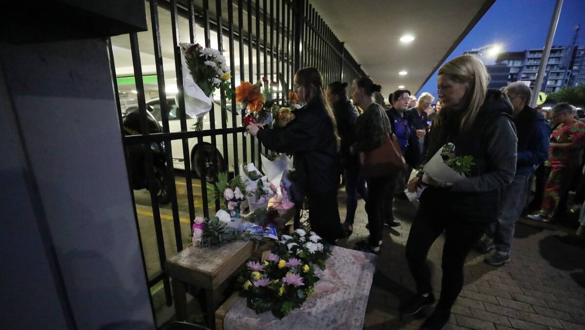 People leave floral tributes for Raymond McCormack. Picture by Robert Peet