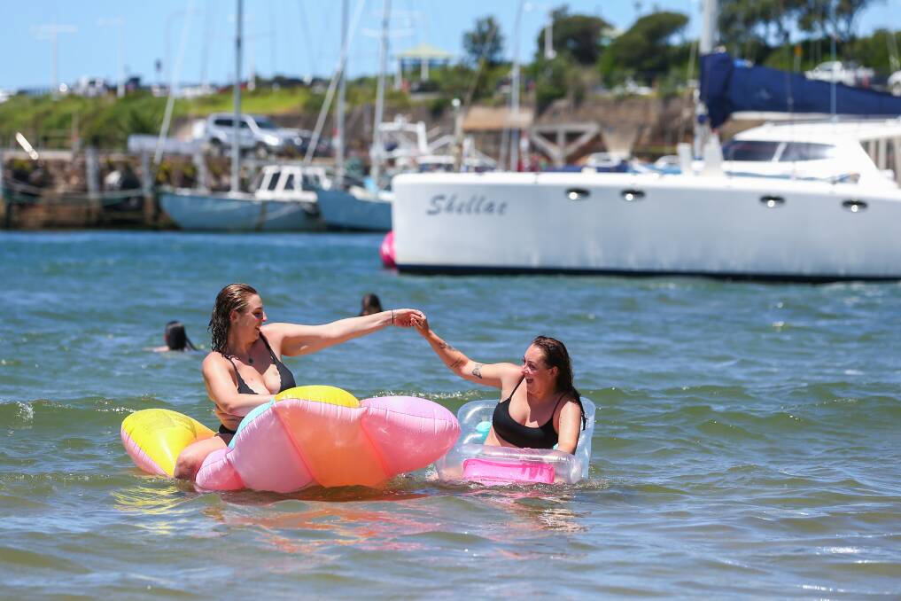 Erin O'Brien and Bec Taylor enjoy the sun and the water on the last day of 2021. Picture: Wesley Lonergan