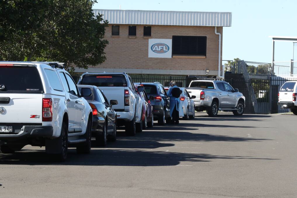 TESTING: Cars queue at the drive-through clinic at North Dalton Park in Fairy Meadow. Picture: Robert Peet