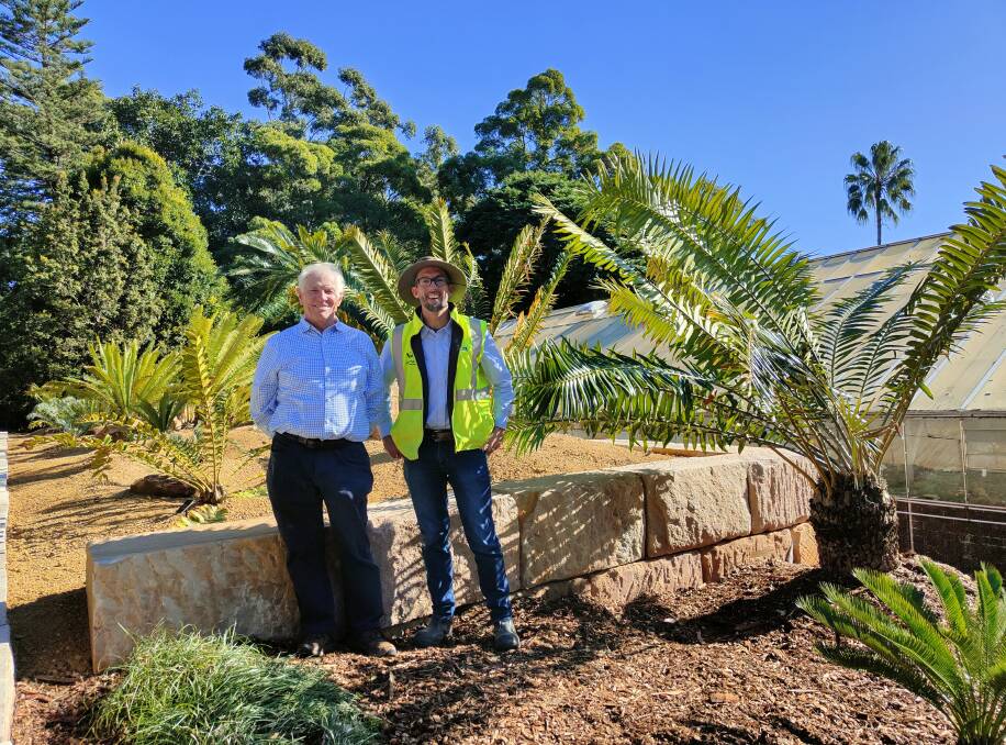Colin Wilson, close family of donors the Edwards family, and Wollongong Botanic Garden's living collections curator James Beattie with some of the cycads. Picture supplied.