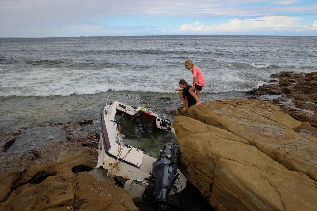 A stricken boat has washed up on the rocks behind Bellambi Rock Pool, one of the latest boating incidents in the area. Picture by Wesley Lonergan.