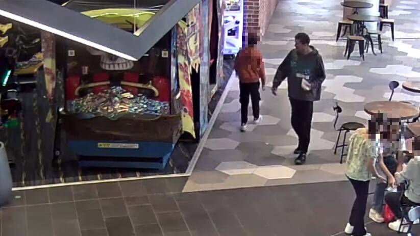 Sex offender Michael Pearce, wearing black pants and a dark-coloured jumper, is seen on CCTV approaching an arcade game booth before molesting a teenage girl.