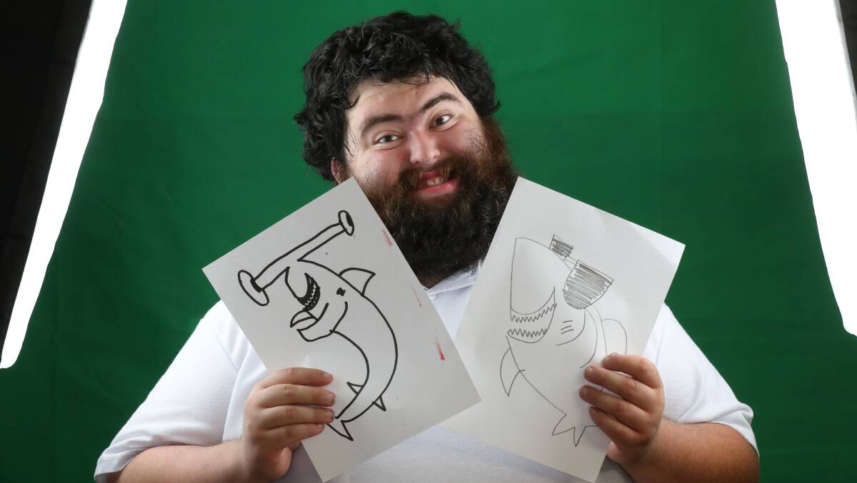 Ricky Gamble with some of his shark drawings, which were animated for the ABC Kids show Fizzy and Suds. Picture by Robert Peet