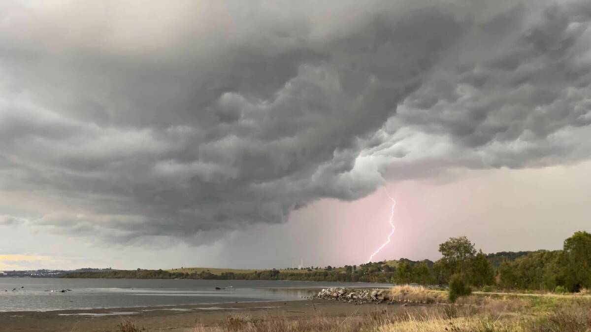 A lightning strike as seen from the shore of Lake Illawarra in Koonawarra. Picture by Nadine Morton
