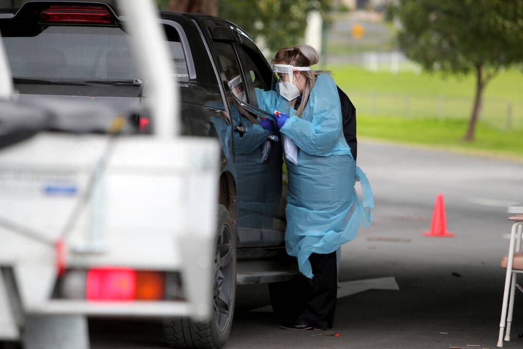 TESTING: A person is swabbed at the Albion Park drive-through clinic. Picture: Sylvia Liber