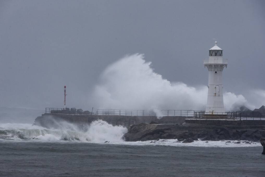 Large surf hits the breakwall near Wollongong Lighthouse. Picture: Anna Warr