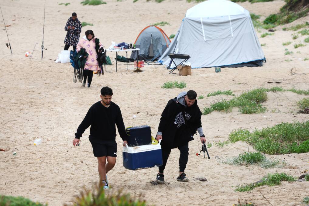 People packing up on Shellharbour North Beach on New Year's Day. Picture by Sylvia Liber
