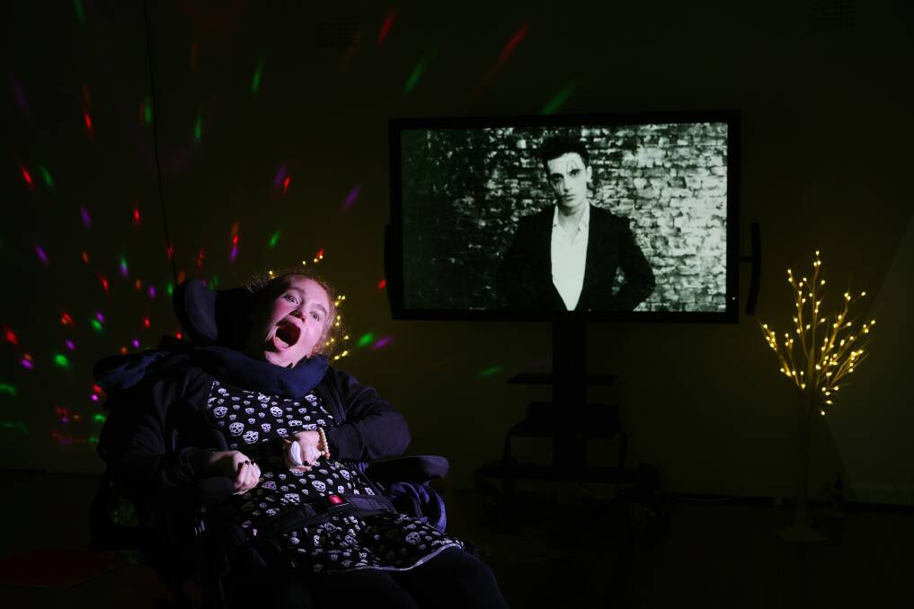 Music therapy participant Laura Boyd in front of a still from the film that was made during the program. Picture by Sylvia Liber