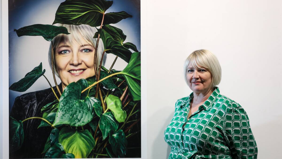 Jo Fisher, pictured beside her portrait taken by Tim Bauer, hopes a new exhibition celebrating Housing Trust tenants will show that housing stress can happen to anyone. Picture by Adam McLean.