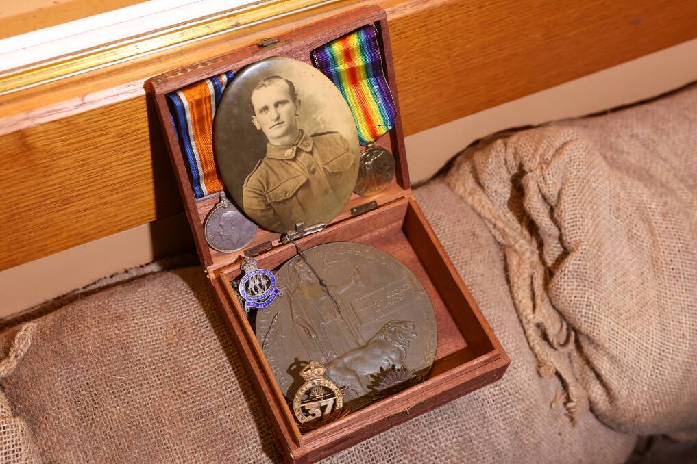 The photographer, medals and badges of Private William George Edwards, in the cigar box in which they were found. Picture by Adam McLean