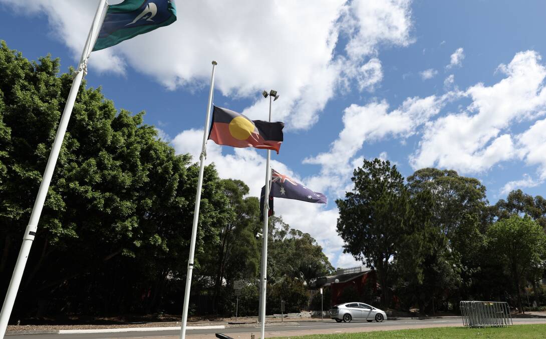 The University of Wollongong flying its Torres Strait Islander, Aboriginal and Australian flags at half-mast on Monday, October 16, following the defeat of the Voice to Parliament. Picture by Adam McLean