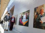 Wollongong Lord Mayor Gordon Bradbery and CWA life member Ada Rayner check out the new exhibition in Bonacina Walkway; Mrs Rayner's photo is in the foreground. Picture: Adam McLean
