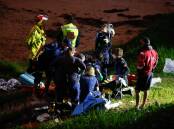 Emergency services attend to an injured woman at Austinmer. Picture: Anna Warr