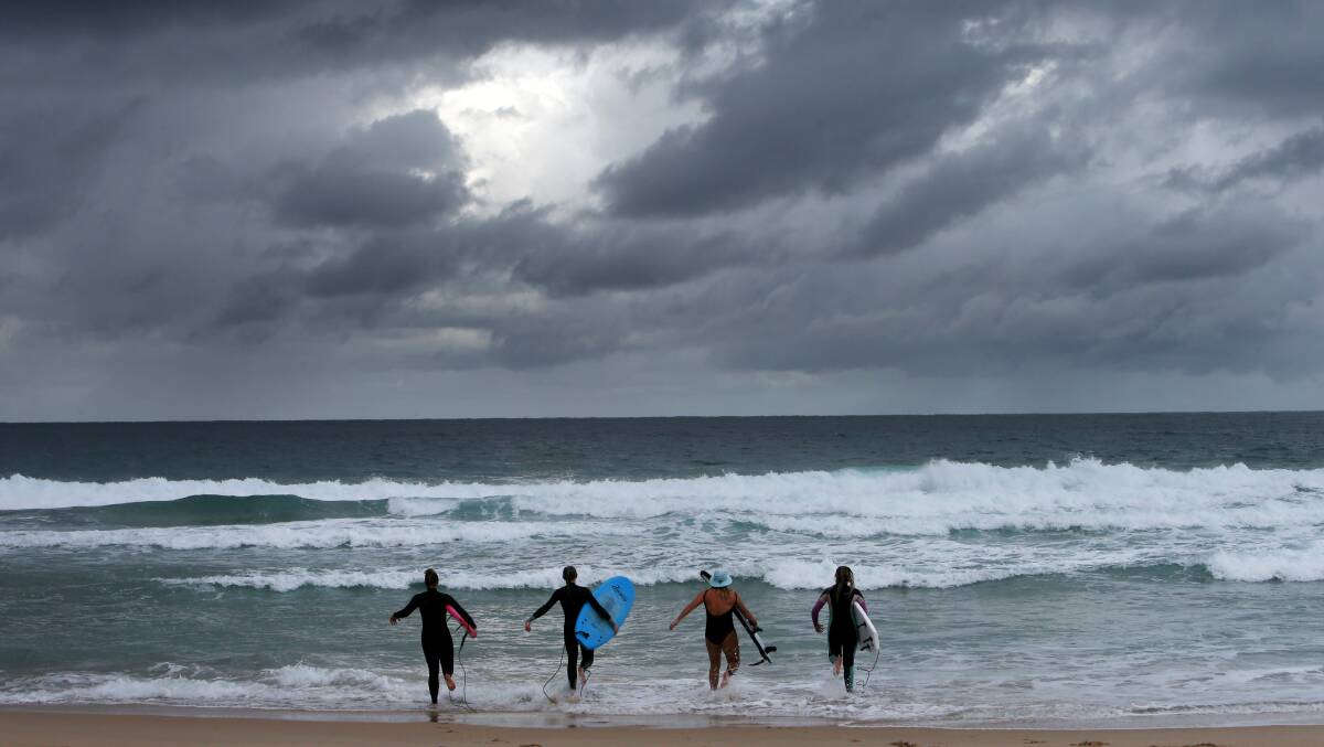 Justine Franklin, Lauren Heaton, Skye Currie and Amy McCamley brave the water at City Beach. Picture: Sylvia Liber