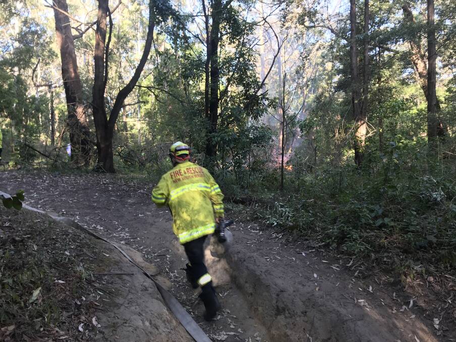 FLAMES: A firefighter rushes to the November 2019 blaze. Picture: Ashleigh Tullis