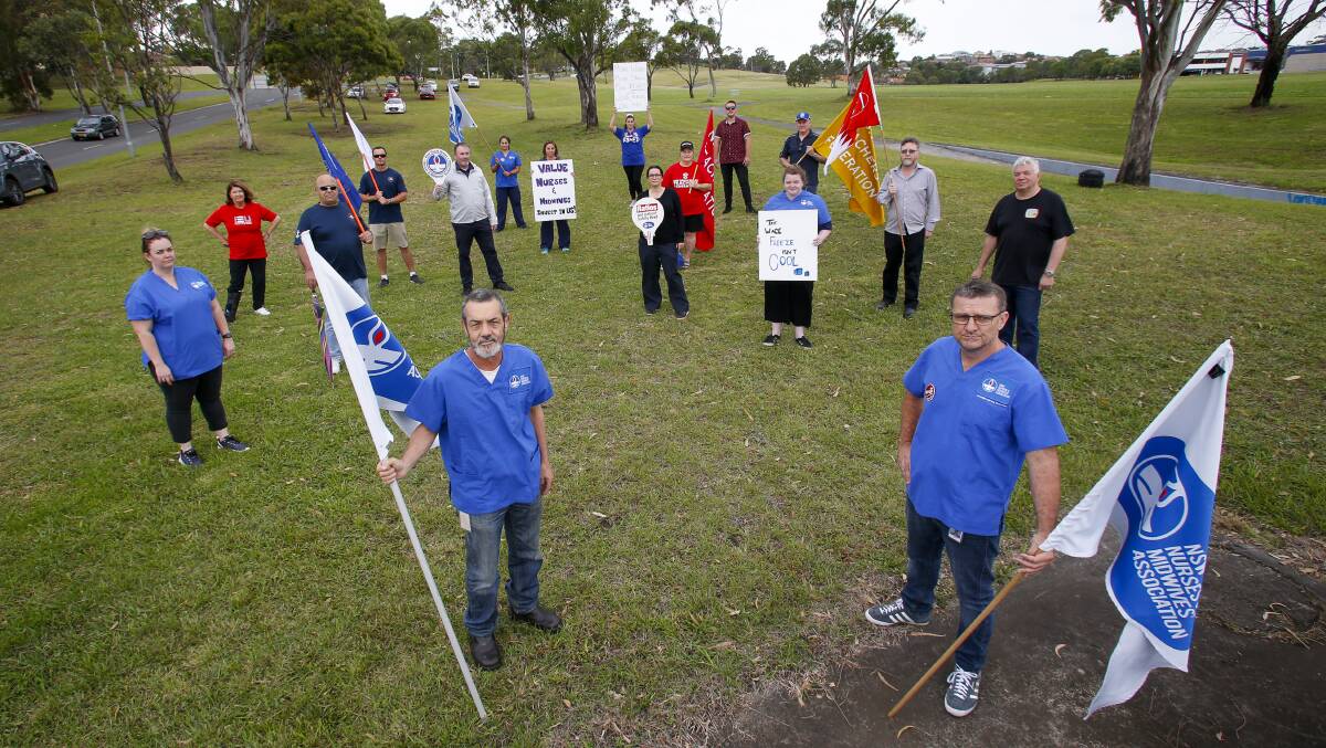 Illawarra Shoalhaven Mental Health Nurses NSWNMA branch president Glenn Hayes and vice president Eddie Barry with other staff and supporters at the midday rally near Shellharbour Hospital. Picture: Anna Warr 