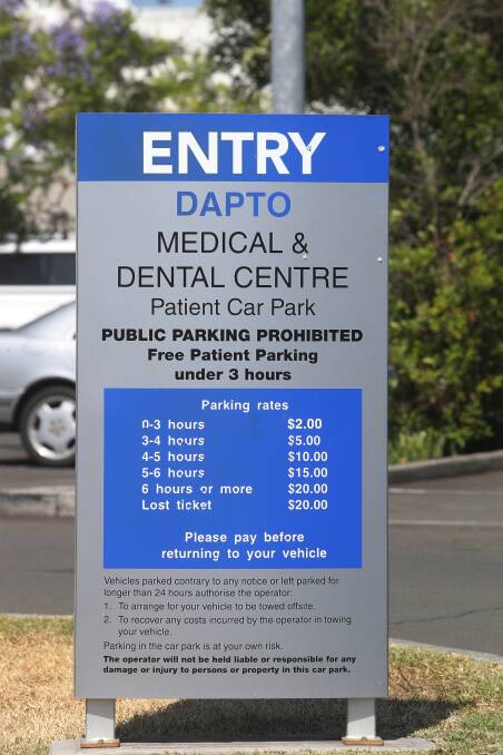 Contradiction: The sign states that there's free patient parking under three hours, yet the small print shows there's a $2 fee for the first few hours. Pictures: Robert Peet