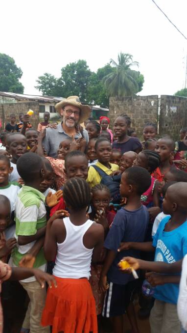 Helping hand: University of Wollongong academic Dr Rob Goodfellow in Liberia last year as a public health volunteer. Pictures: Supplied
