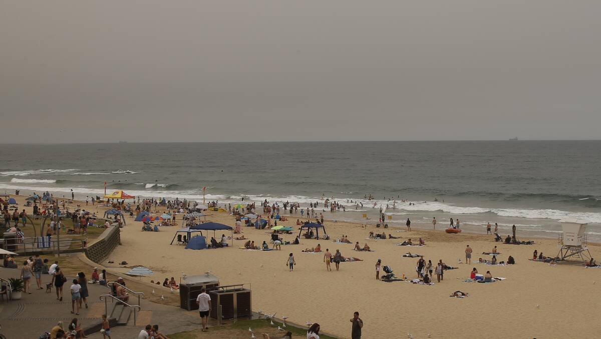 Persistently poor: Smoke haze has been a feature of South Coast skies for weeks now - such as this December 29 photo at North Wollongong beach. Picture: Anna Warr