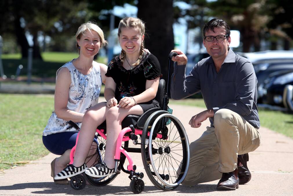 Clara Bates, pictured in December 2016 with Belinda Dawson and Troy McDonald, when Wollongong businesses were pitching in to get her a new wheelchair.