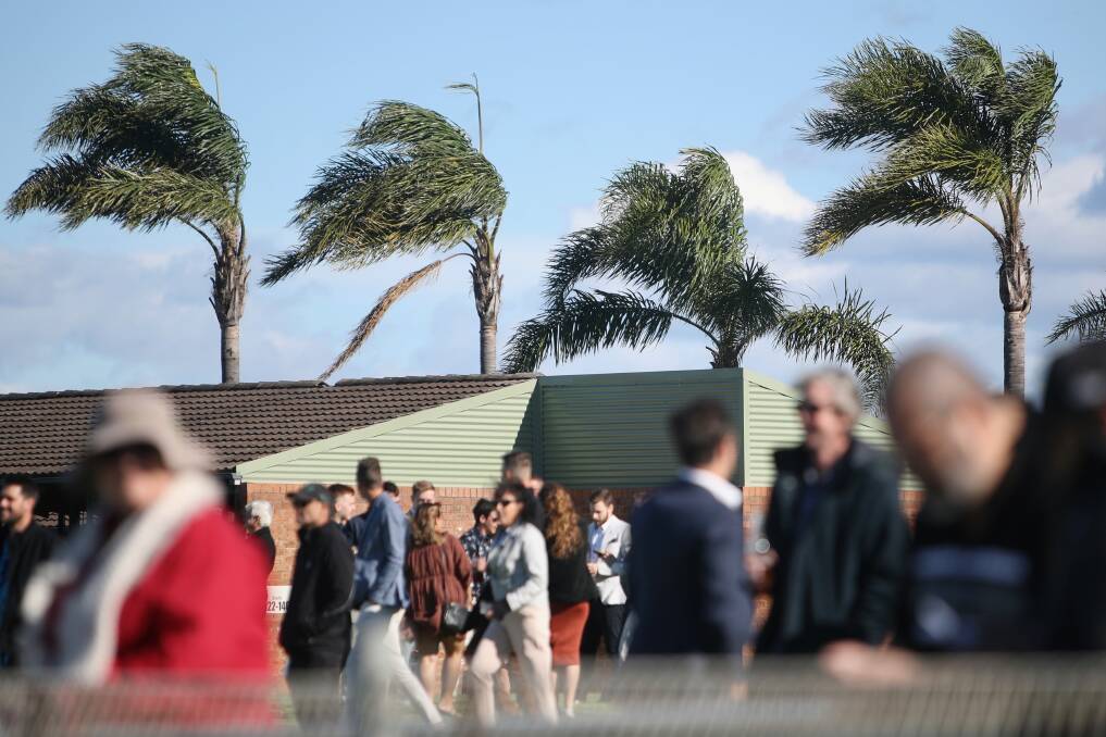Patrons put up with wild, windy weather at Kembla Grange racecourse on Saturday afternoon. Picture: Adam McLean