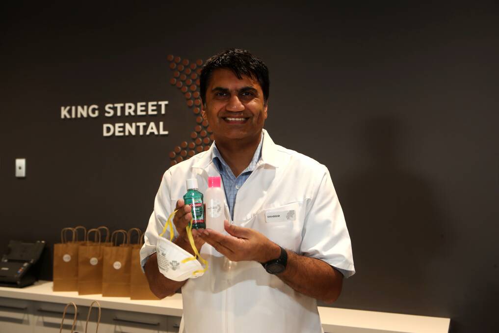 Good deed: Warrawong dentist Dr Shabbir Kermali is sharing his centre's commercial supply of hand sanitiser with vulnerable community members by creating individual hygiene packs. Picture: Sylvia Liber