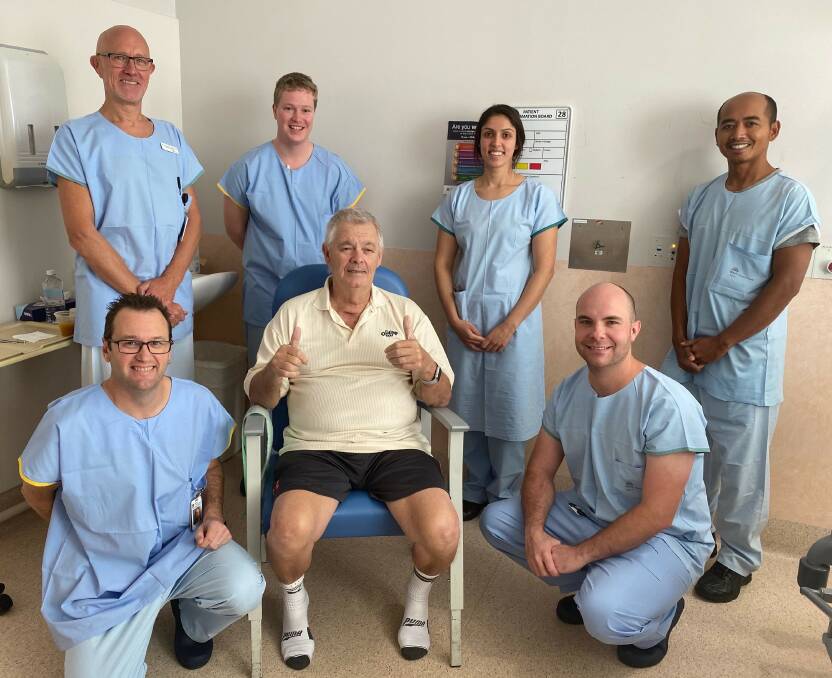 Henry Karpik pictured this week with Dr Alan Davey-Quinn and other Wollongong Hospital COVID ICU staff. Picture: Supplied