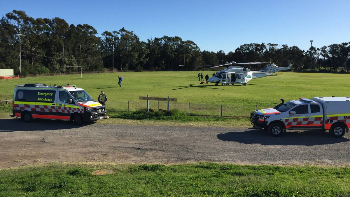 NSW Ambulance rescue helicopter has arrived with the crew members at Tom Willoughby Oval. Picture: Robert Peet