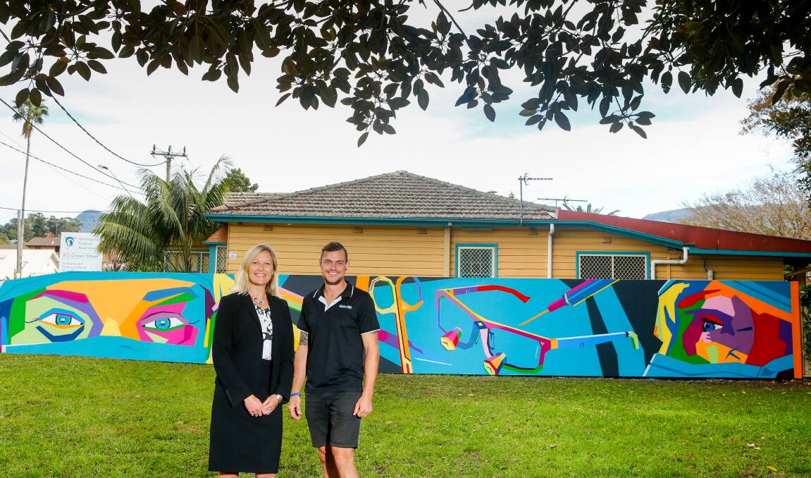 Surgical theme: Wollongong surgeon Soni Putnis with aerosol artist Anthony Jones and the mural he's created at her Crown Street practice. Picture: Adam McLean