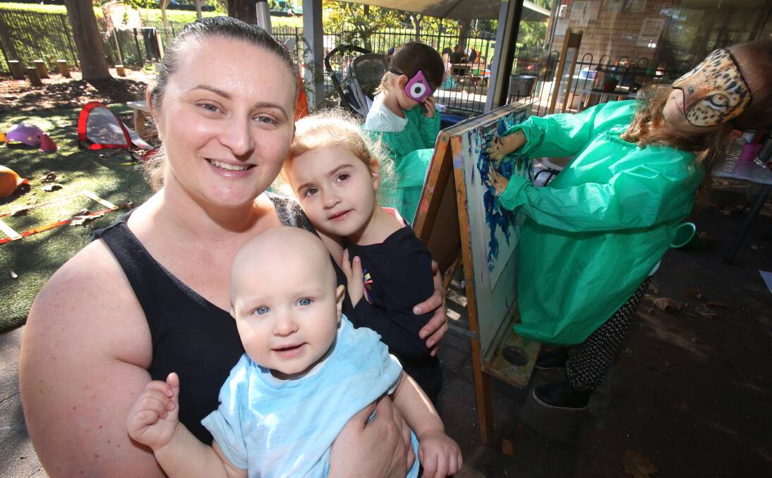 Raising awareness: Anita Rowles - with 10-month-old son Patrick and daughter Vivien, 3 - leads a blindfolded painting exercise with Lola Norris and Zara Zikic at Keiraview Children's Centre. Picture: Robert Peet