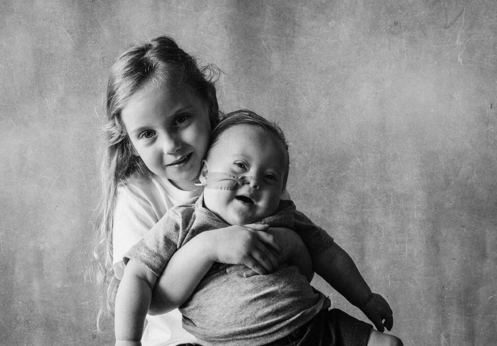 Nowra's Luca Cullen, with sister Sienna. They were among the families who took part in a photo shoot as part of a fundraiser for a new book for families with a new diagnosis of Down syndrome. Picture: Ann Young