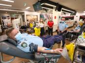 Lake Illawarra police officer Peter Northey (front) with LifeBlood representatives Lyn Lindley and Megan Green and colleagues Damien Turner and Angela Burnell at the Wollongong Blood Donor Centre. Picture: Adam McLean
