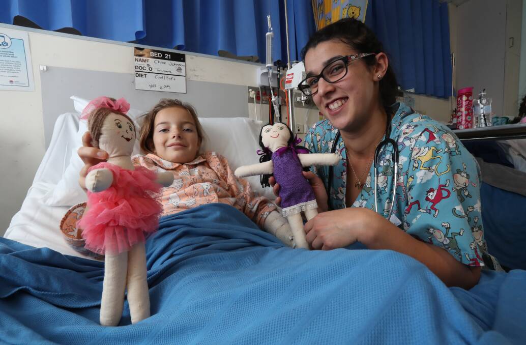Birthday surprise: A ballerina doll made by aged care residents was appreciated by Warrawong's Chloe Johnson, pictured with nurse Ivone Outeiro. Picture: Robert Peet