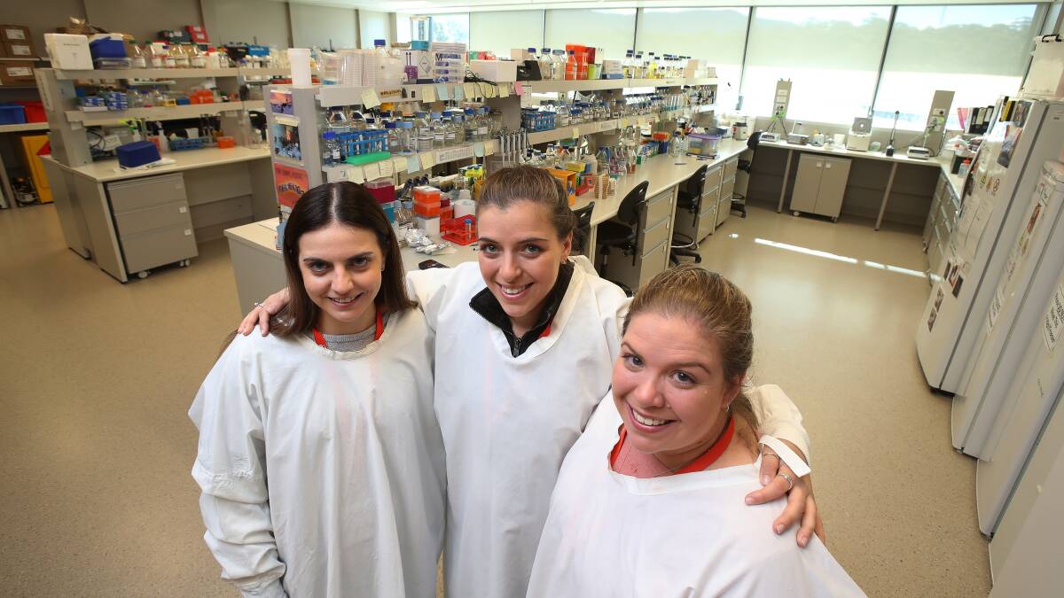 Strong bond: Rebecca Young and Kaitlin and Jessica Ellis at the Illawarra Health and Medical Research Institute to learn about the research into MND. All three carry a gene mutation that triggers the disease. Picture: Robert Peet