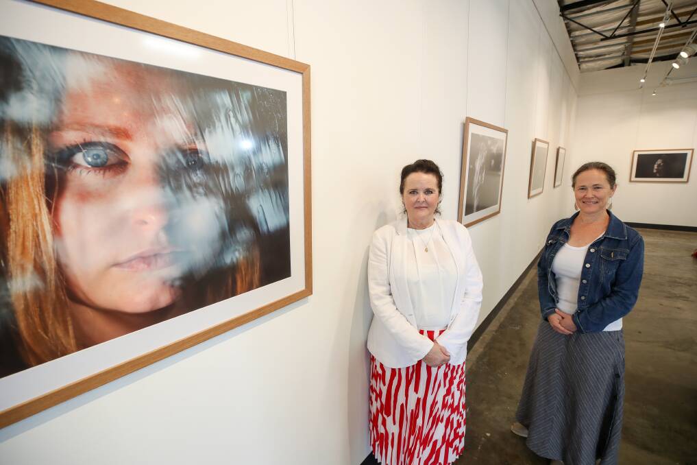 Shellharbour MP Anna Watson with Sally Stevenson, the general manager of the Illawarra Women's Health Centre, at the exhibition now showing at Project Contemporary Artspace in Wollongong. Picture: Adam McLean