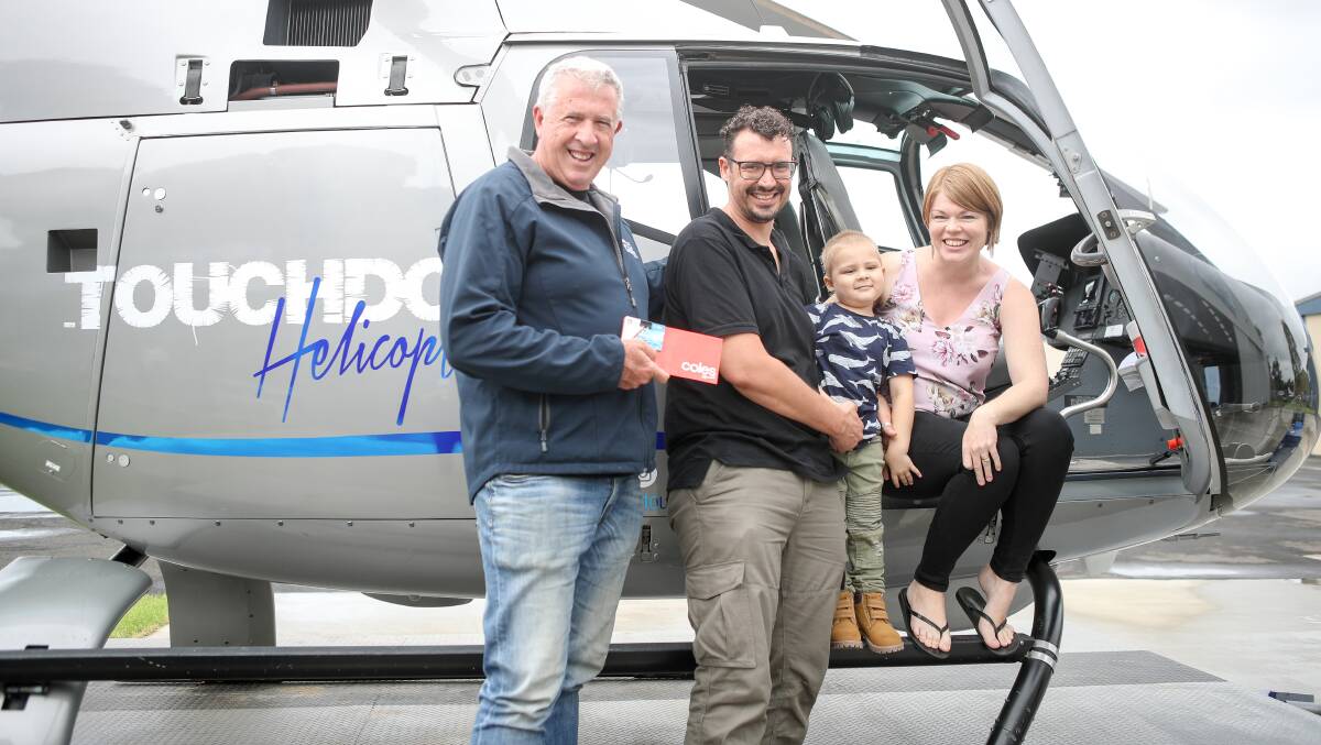 i98FM breakfast announcer, and Convoy founder, Marty Haynes, hands over the vouchers to the Tomaz family. Picture: Adam McLean
