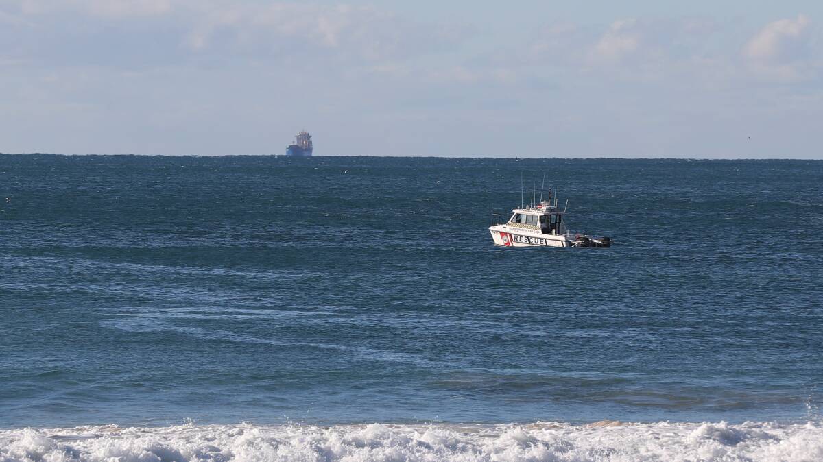 A Marine Rescue boat searching off North Beach, Wollongong, on Sunday morning. Picture: Robert Peet