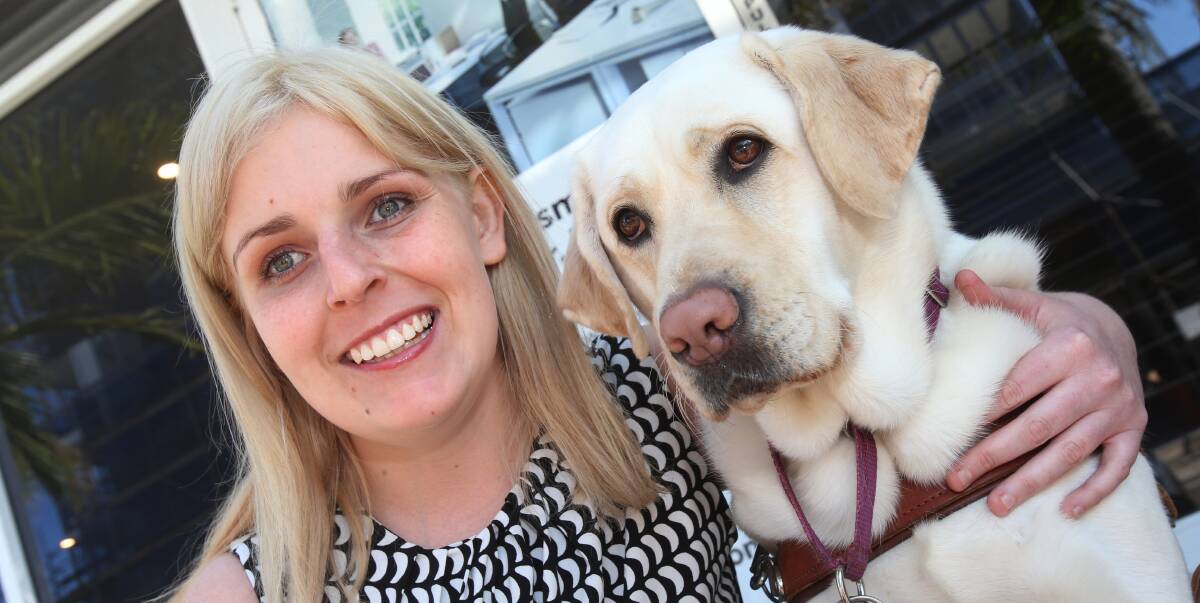 Official opening: Kimberlee Brooker with her guide dog Toffee outside the new Guide Dogs NSW Wollongong office in Burelli Street. Picture: Robert Peet