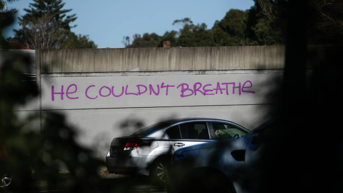 In Bellambi, the words 'He couldn't breathe' have been graffitied on the noise barrier wall at the intersection of Bellambi Road and Memorial Drive. Photo: Adam McLean