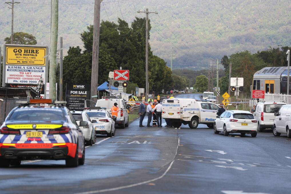 Emergency response: Investigations continue into the crash near the level crossing at Kembla Grange. Picture: Robert Peet
