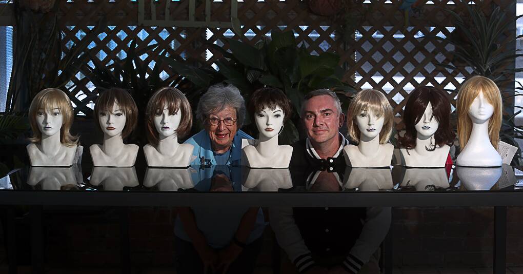 Donation: Illawarra Palliative Care Volunteer Service president Liz Inglis and Illawarra Community Foundation's Mark Rigby with some of the new wigs. Picture: Robert Peet