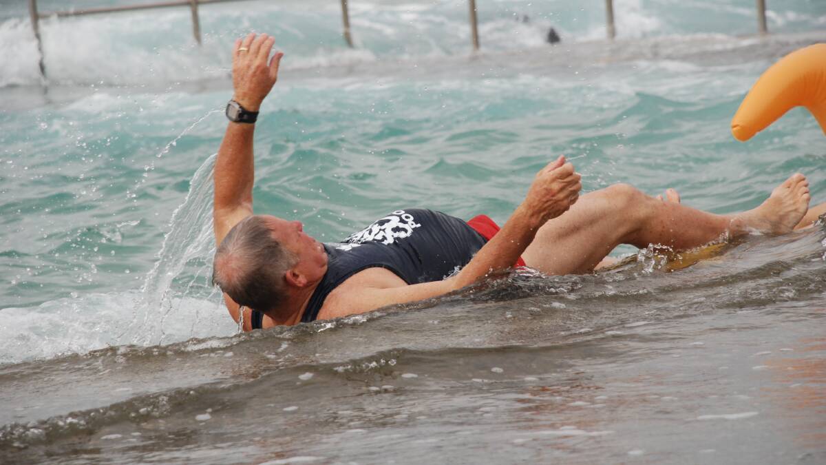 An inelegant finish was not enough to dampen Mr Murray's spirits as he swam to raise money for local sufferers. Picture: Meg Powell