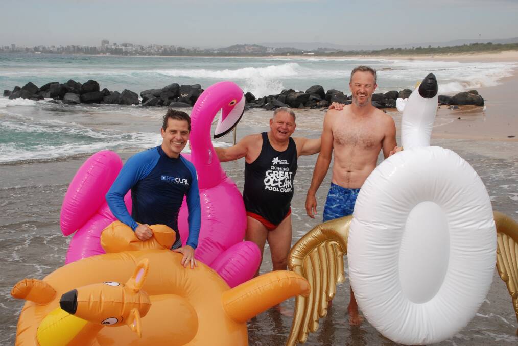 Flailing with floaties: Keira MP Ryan Park, organiser Phil Murray and former Hawk Glen Saville conquered the waves to raise funds for charity. Picture: Meg Powell