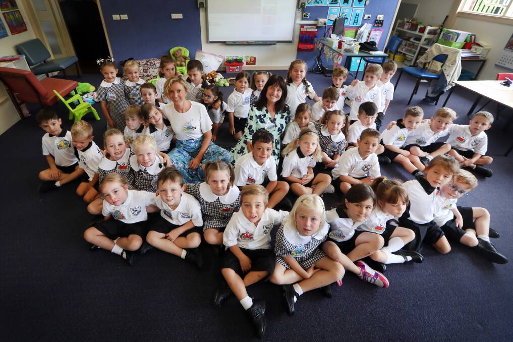 Ready to learn: The two Balgownie kindergarten classes pose with their new teachers on their first day of school. Picture: Sylvia Liber