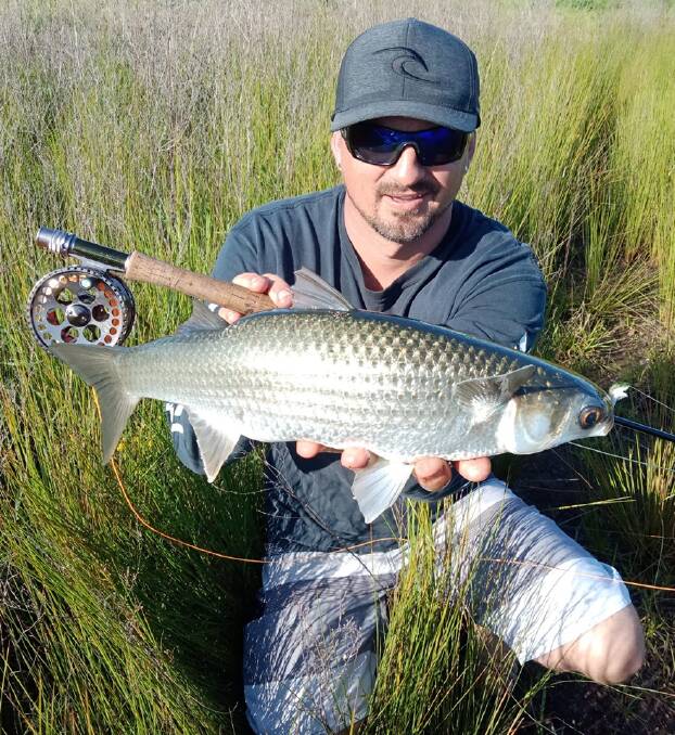 Damien Skeen with a sensational capture of a fly caught mullet.