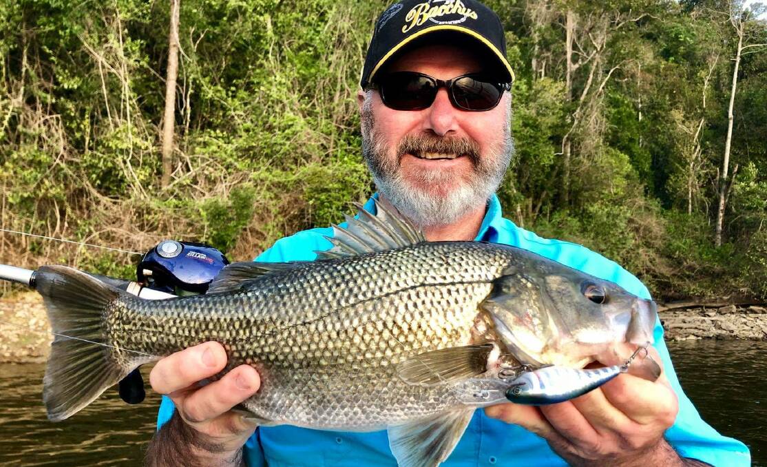Irresistible: Renowned Deception lure maker Paul Kneller, proudly showing a solid bass caught on one of his lures.