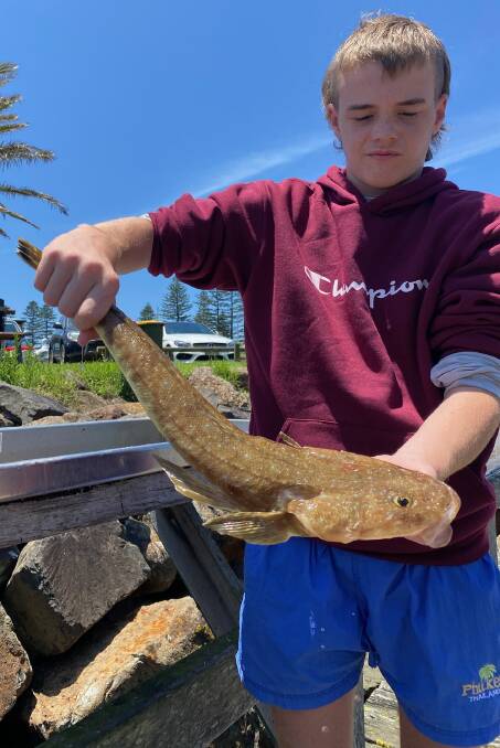 Leaping lizards: Taylan Black with a sand flathead caught off Kiama recently.