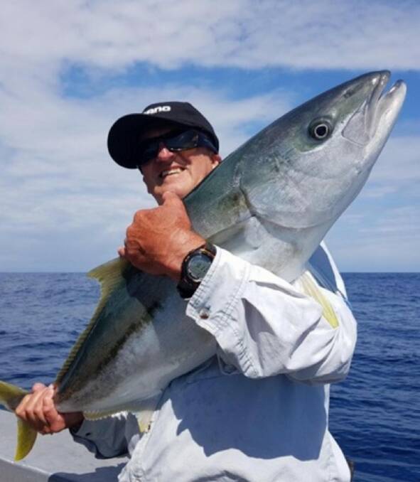 King of the world: Alan Kerr struggles to hold a thumping big New Zealand kingfish from a recent trip.