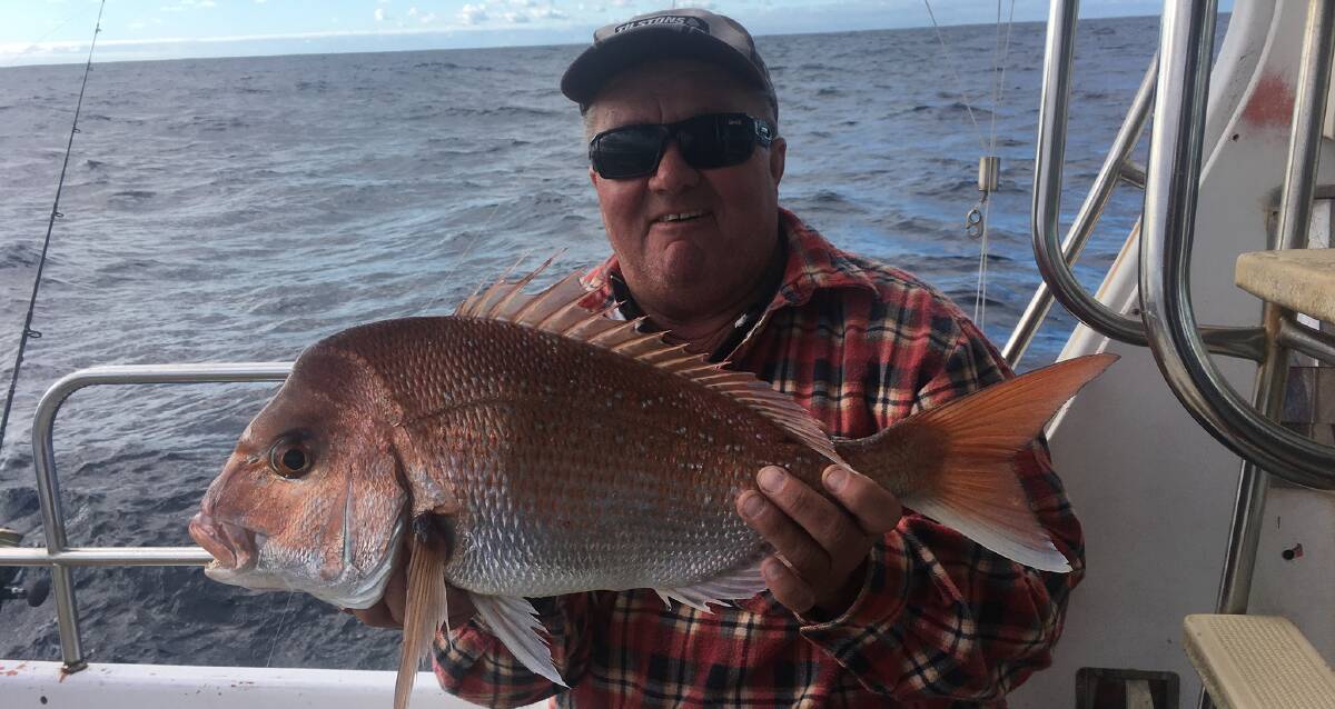 BIG RED BOUNTY: Wes McKenna with his snapper caught during his Shellharbour Fishing Charters trip last weekend.