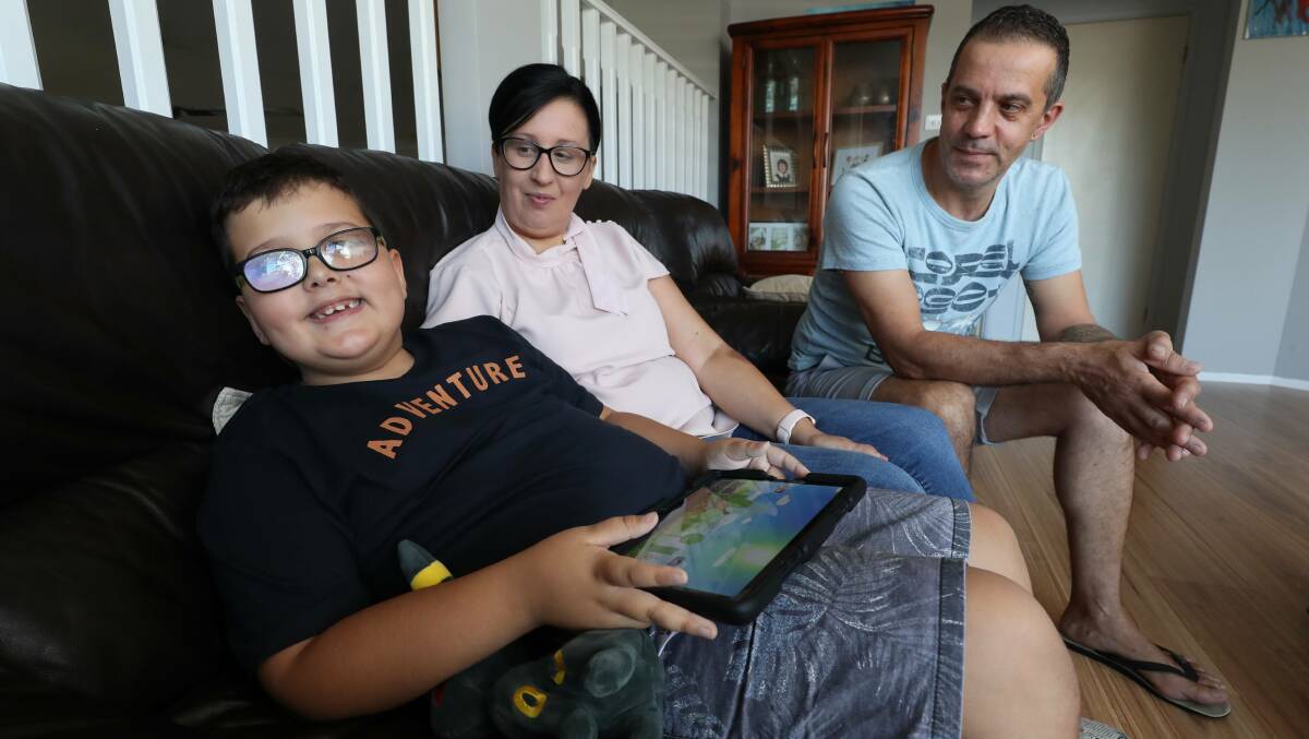 Ongoing struggle: Albion Park parents Sonya and Tony Caldeira with their son Kayden, 7. Picture: Robert Peet